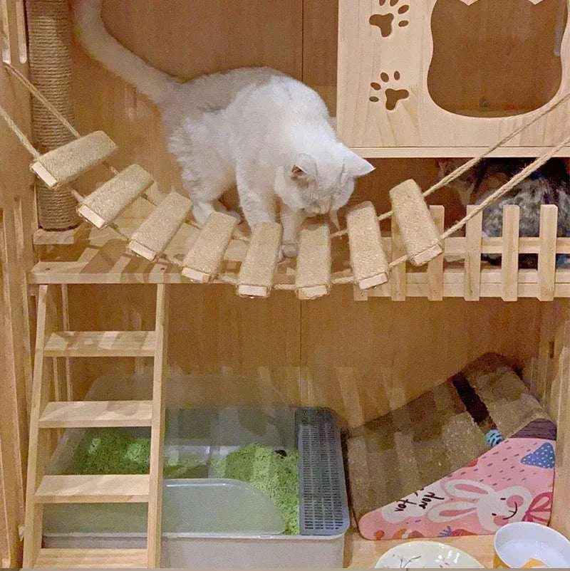 Cat ladder made from natural wood and sisal rope with wooden steps and platforms, featuring a white cat climbing on it
