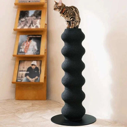 Black modern Cat Scratching Post with wavy textured design and a cat standing on top