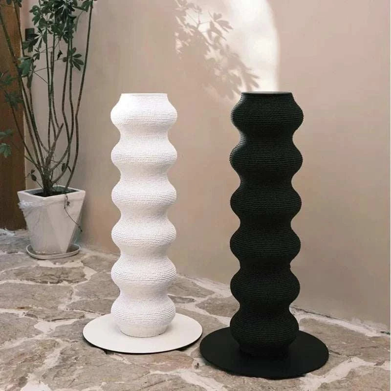 Cat Scratching Post pair in black and white with a tall, wavy textured design on round bases for indoor use