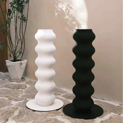 Cat Scratching Post pair in black and white with a tall, wavy textured design on round bases for indoor use